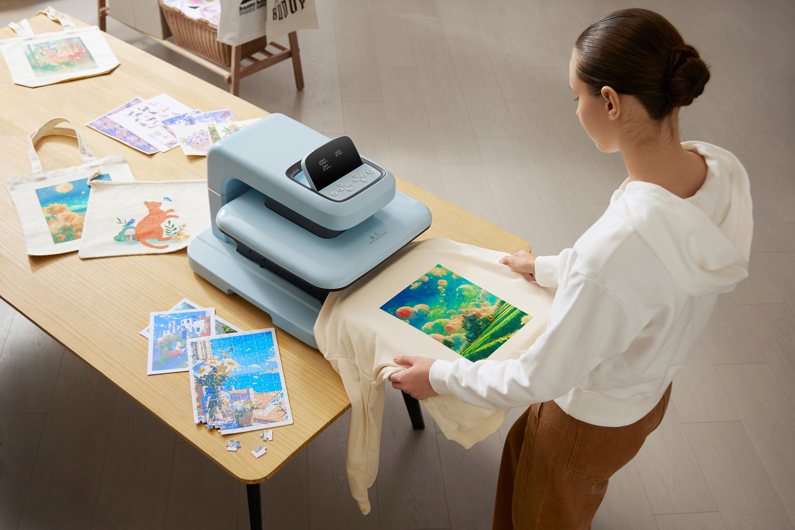 A woman positions a printed sweatshirt beneath an automatic heat press